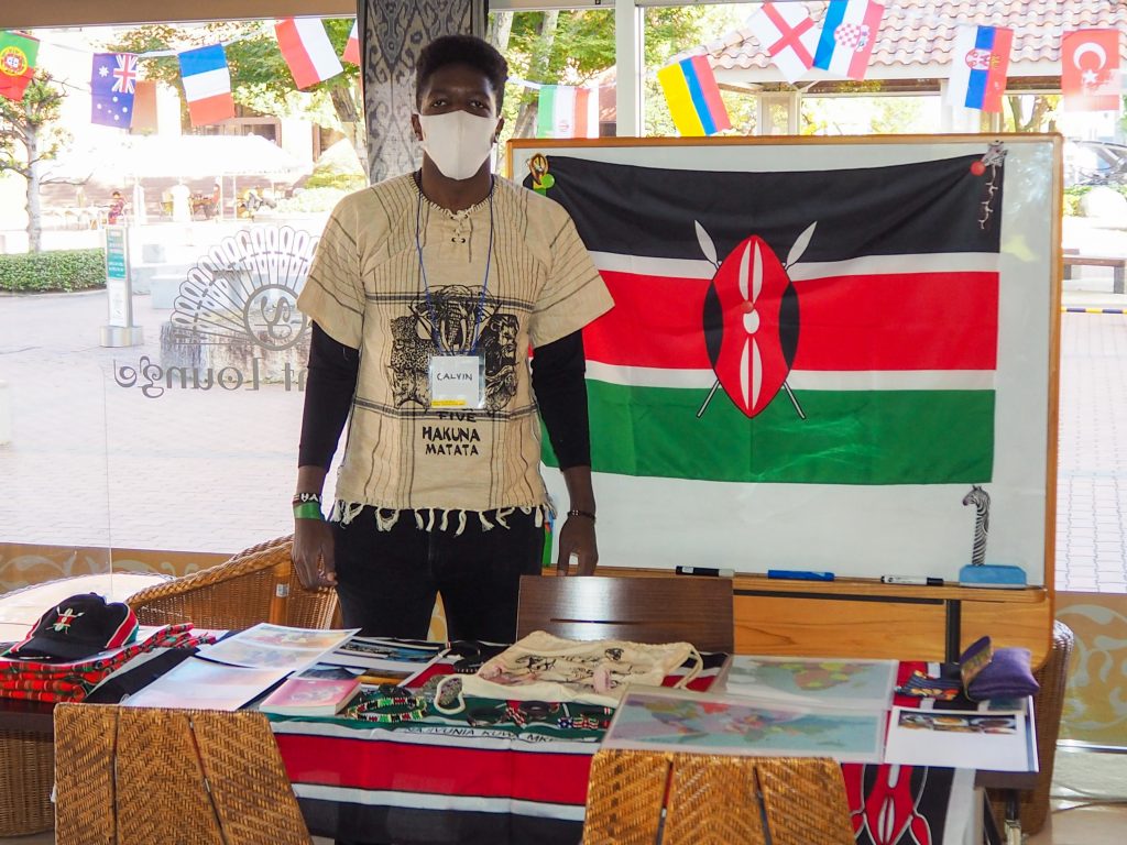 International student from Kenya showcasing culture booth at campus event