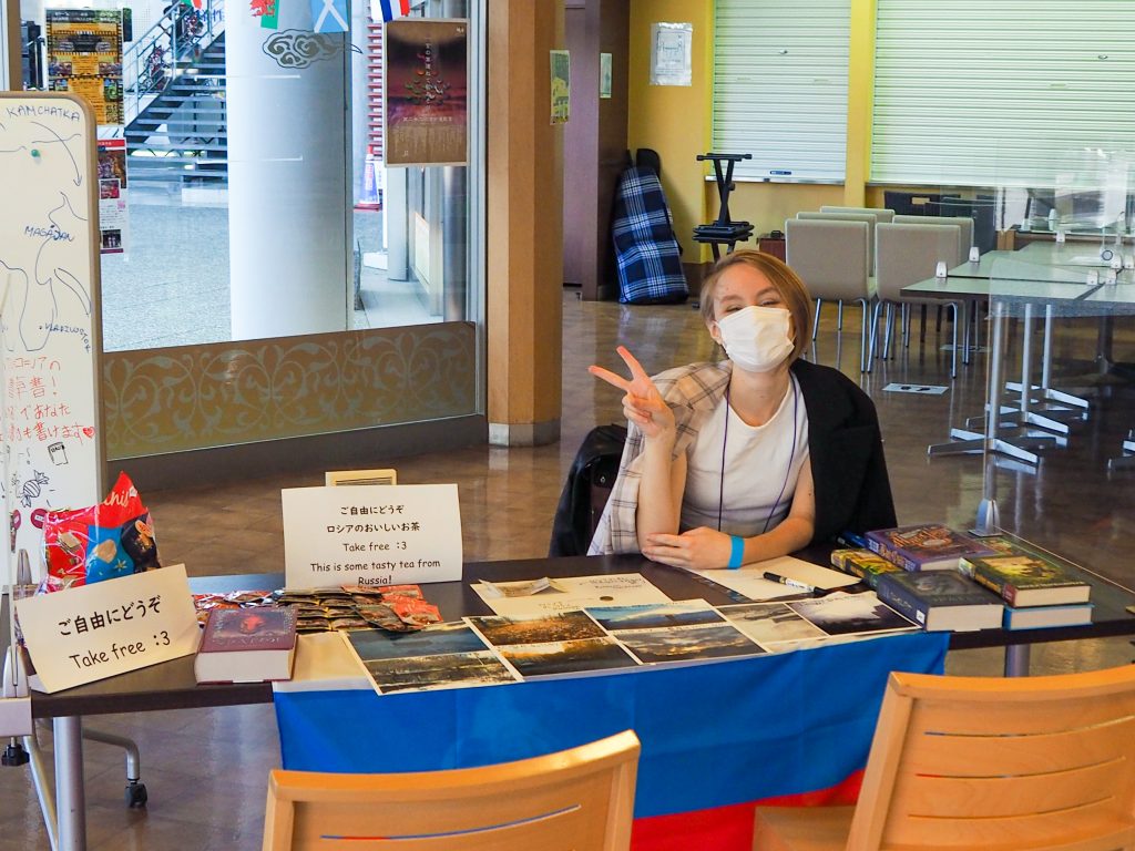 International student from Russia showcasing culture booth at campus event
