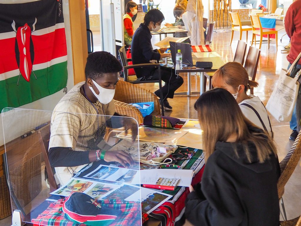 Kenyan international student explaining culture to diversity event visitors