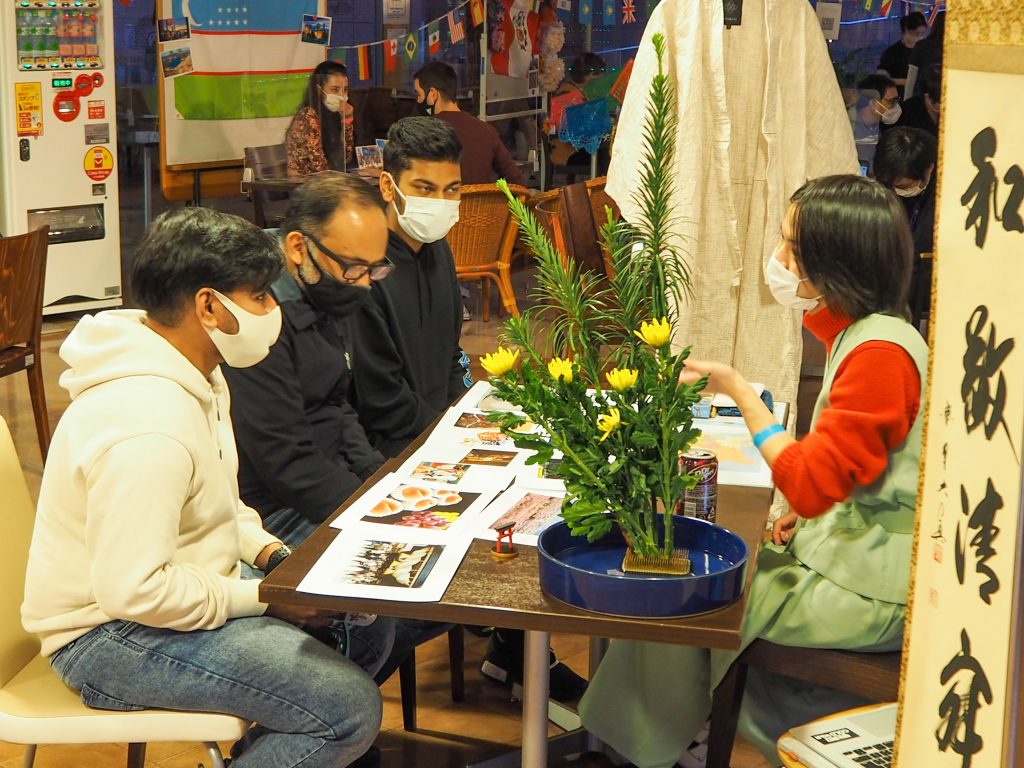 Student explaining Japanese culture to diversity event visitors
