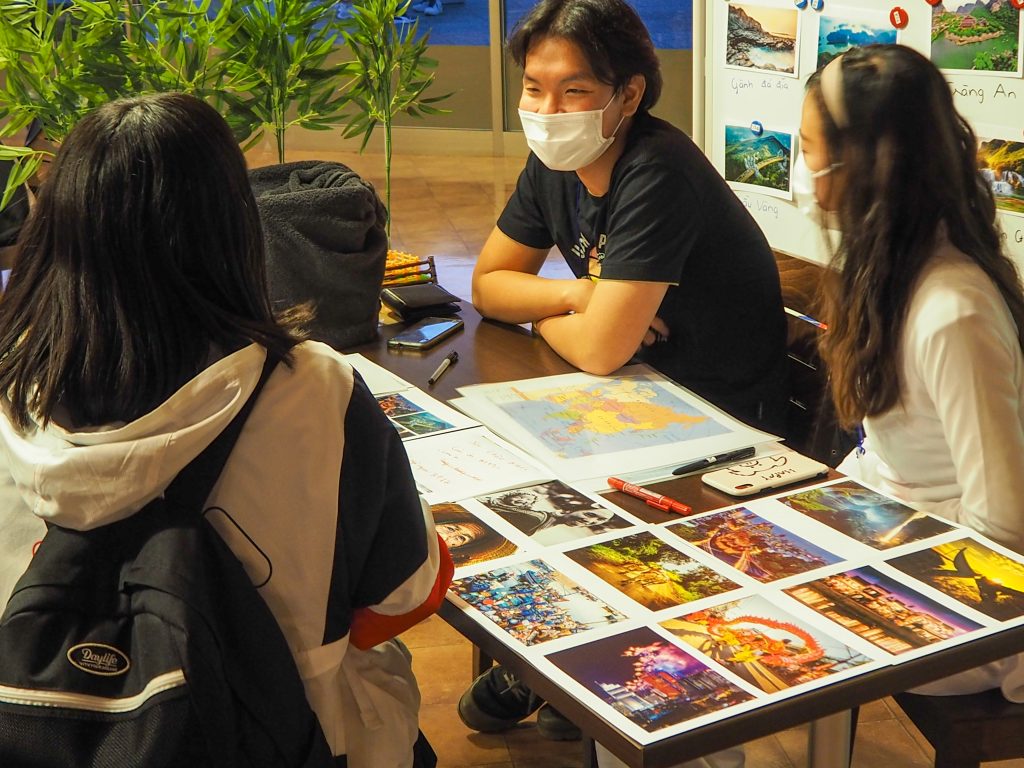 Vietnamese international students explaining culture to diversity event visitors