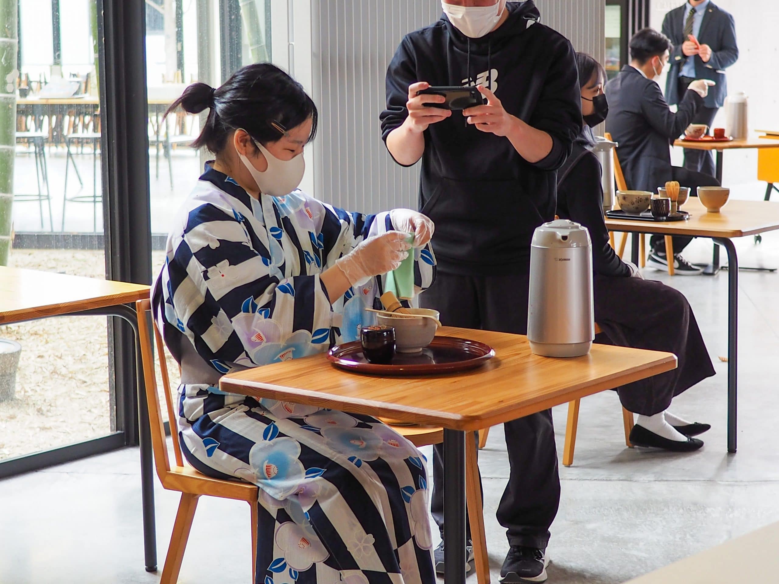 A student is preparing Japanese tea for visitors
