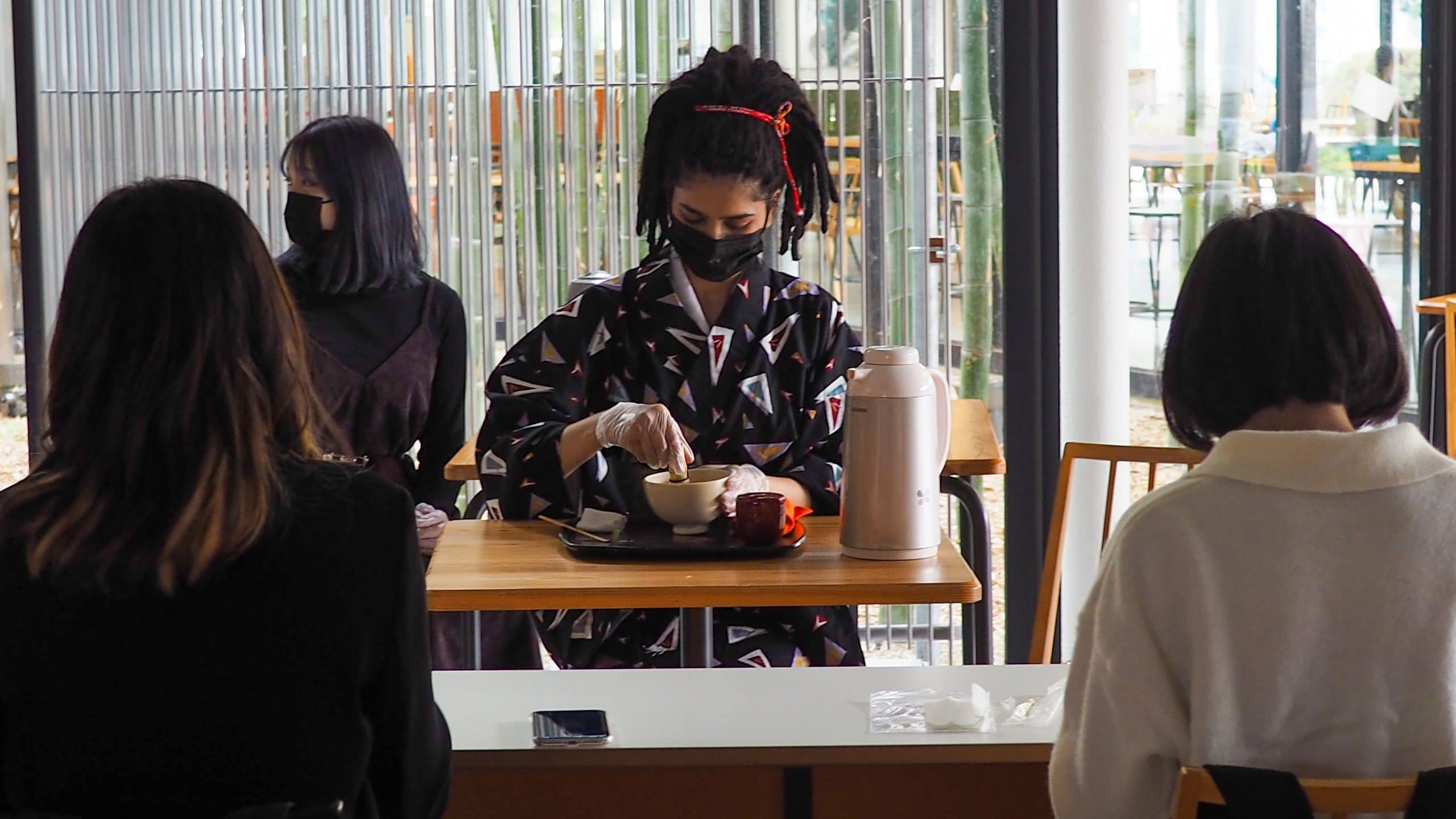 An international student is performing Japanese tea ceremony for visitors 