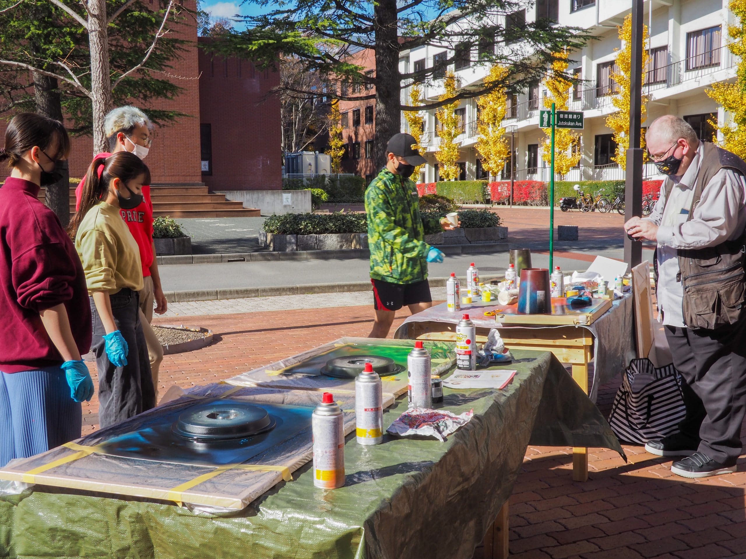 Spray paint art workshop held outside of the iCLA Art Studio