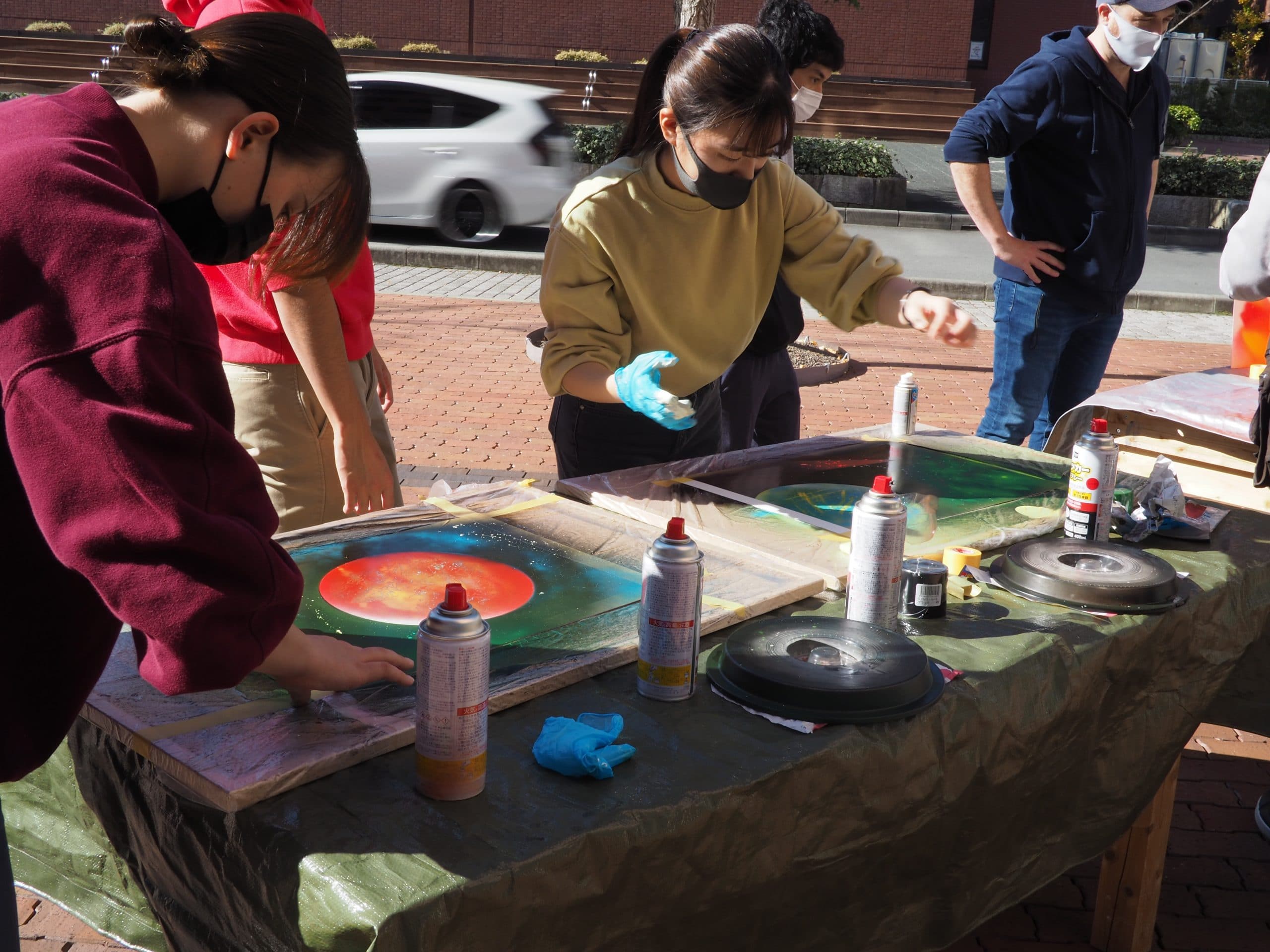 iCLA students working with spray paint to make artwork