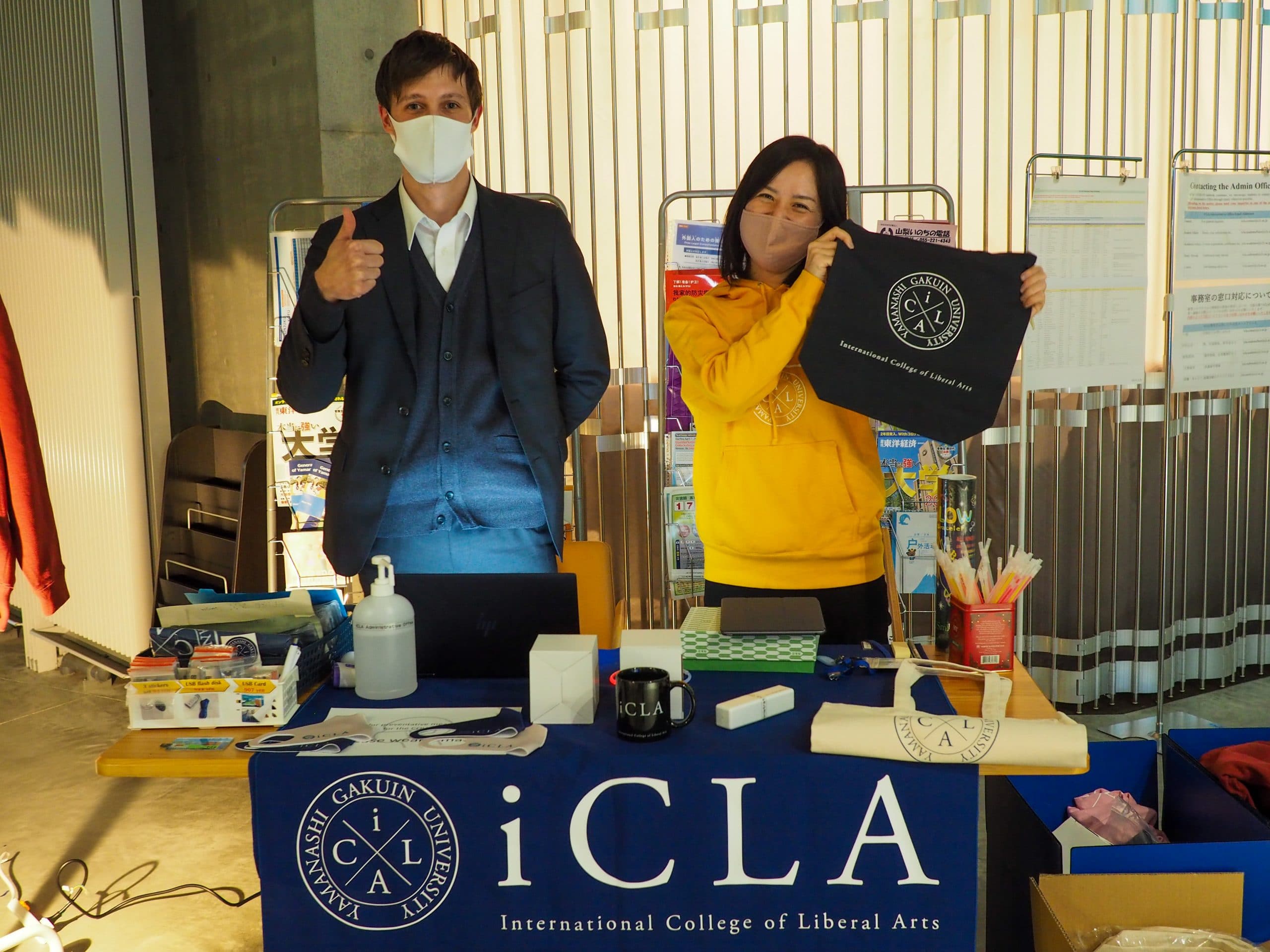 Staff members at desk selling iCLA goods at the Winter Gala