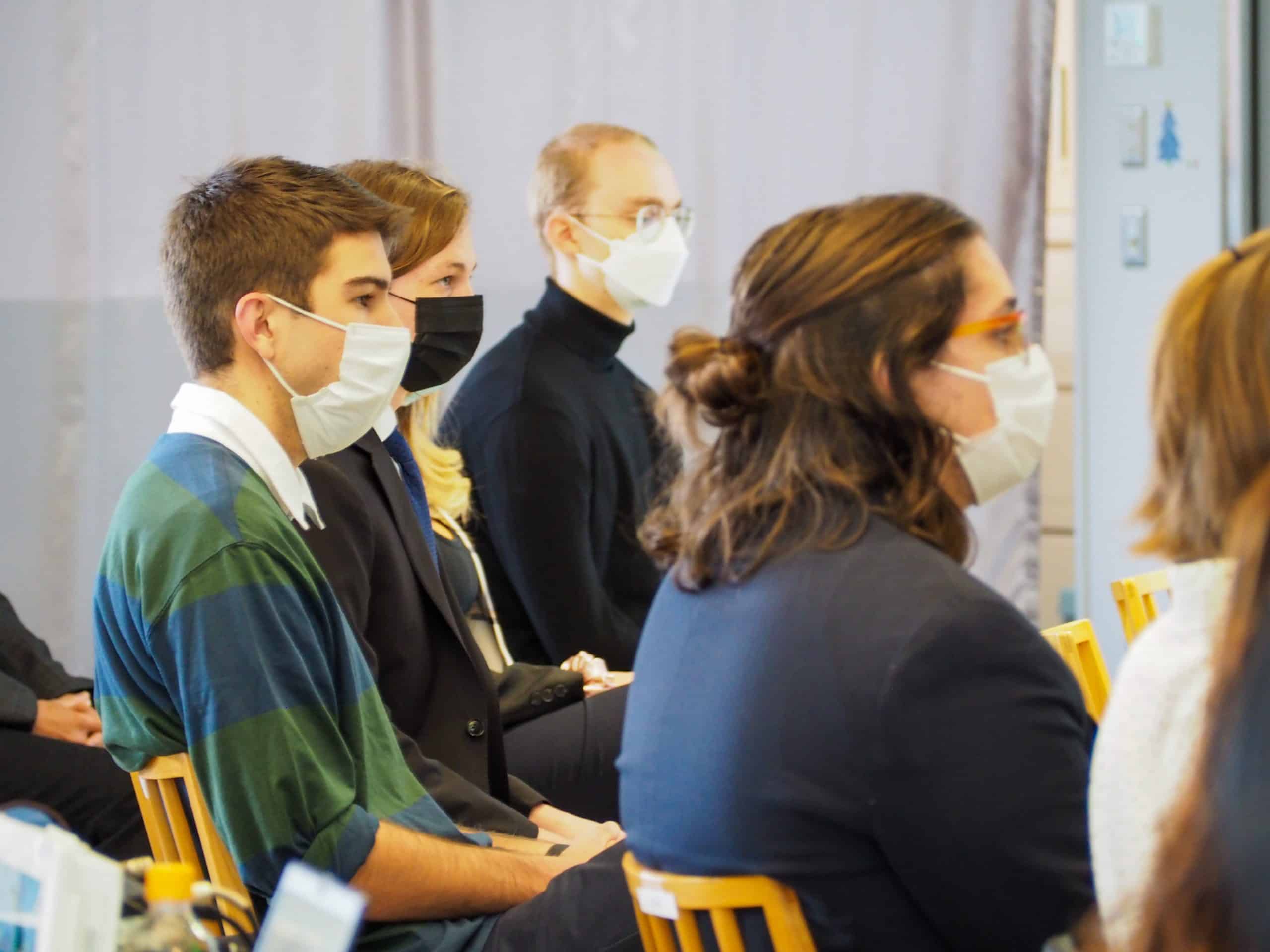 iCLA international students sitting in the audience listening to the President's speech