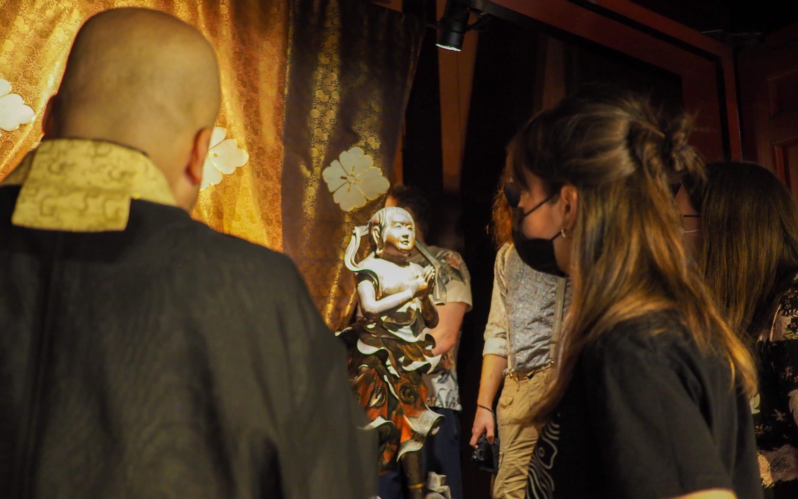 Head priest and iCLA exchange student looks at Erinji's cultural artifacts