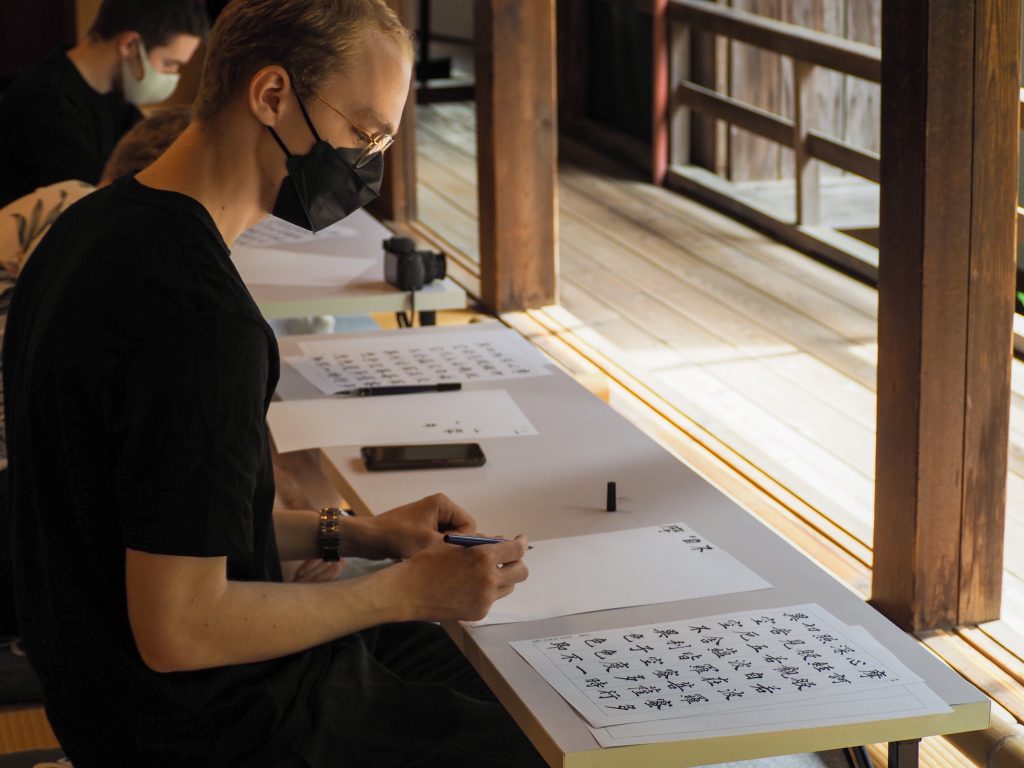 International student practices Japanese calligraphy