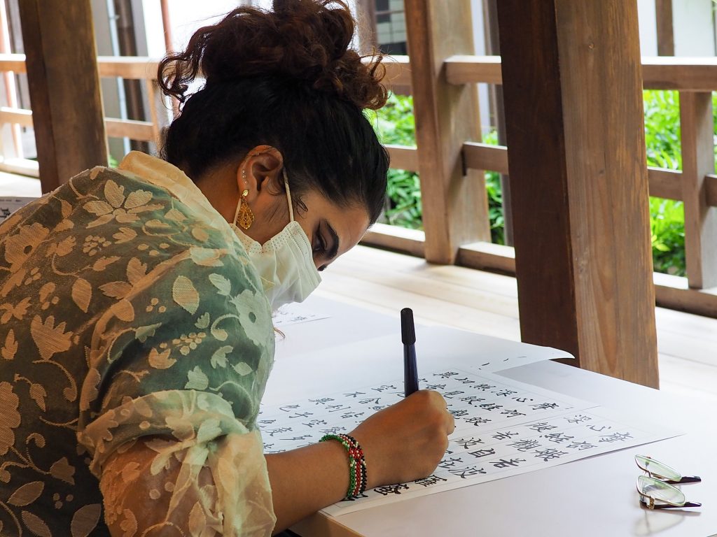 International students practice Japanese calligraphy at Erinji Temple