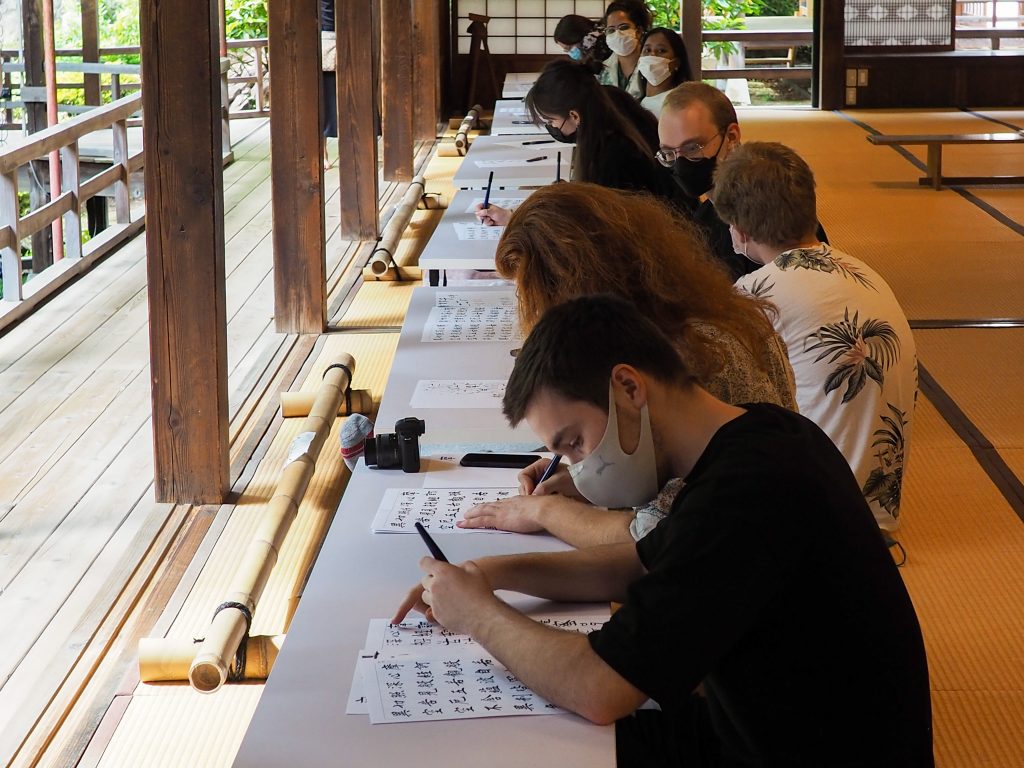 International students practice Japanese calligraphy at Erinji Temple