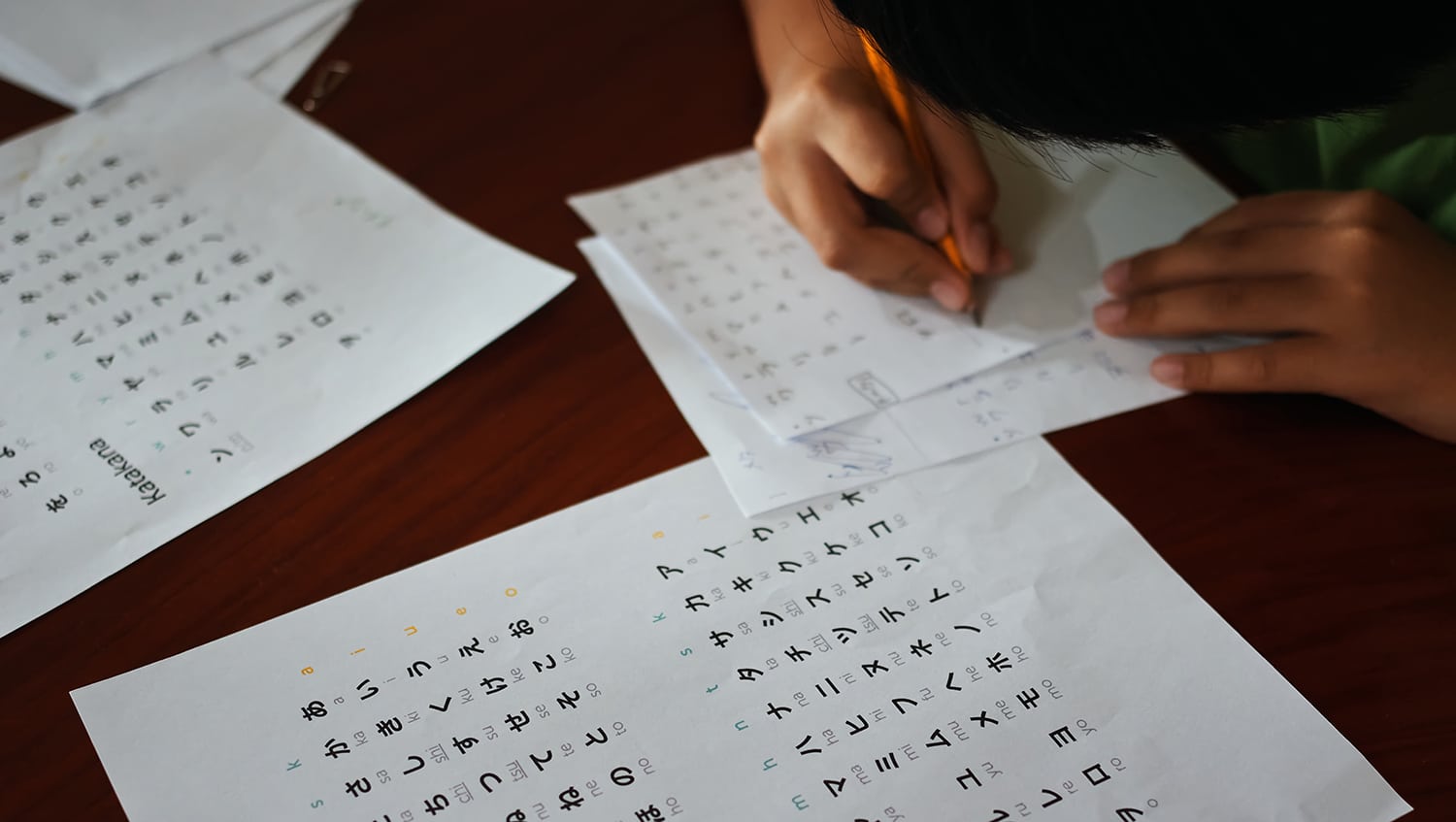 Boy writing Japanese characters