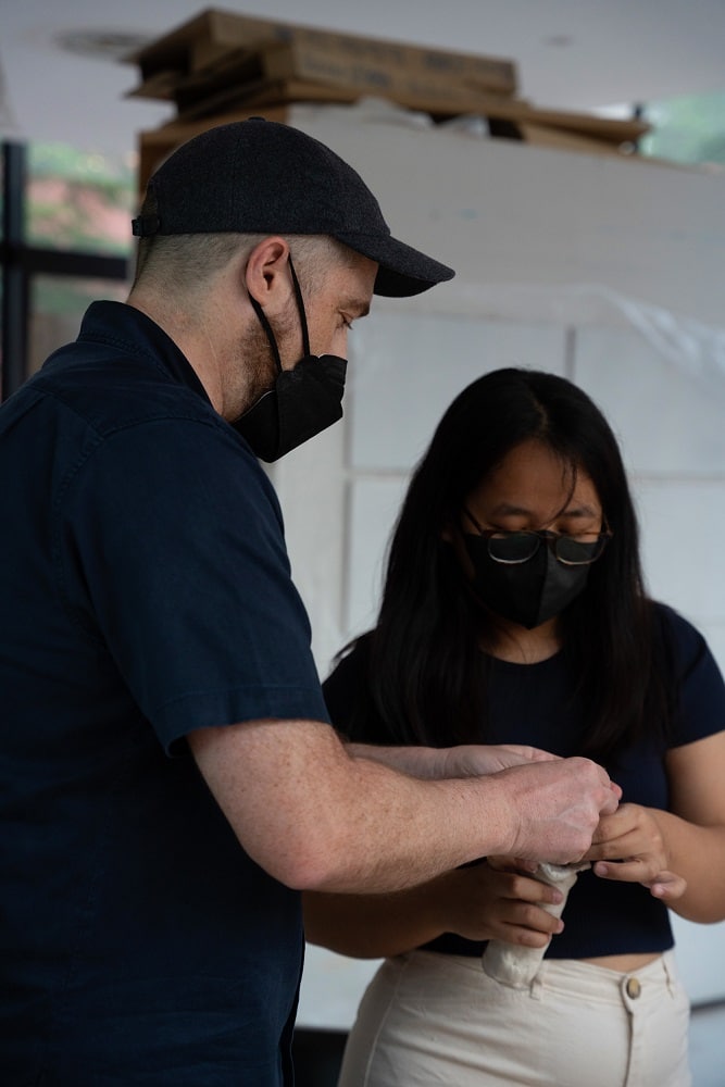 Dr. Sam Stocker assisting an iCLA student on her sculpting project.