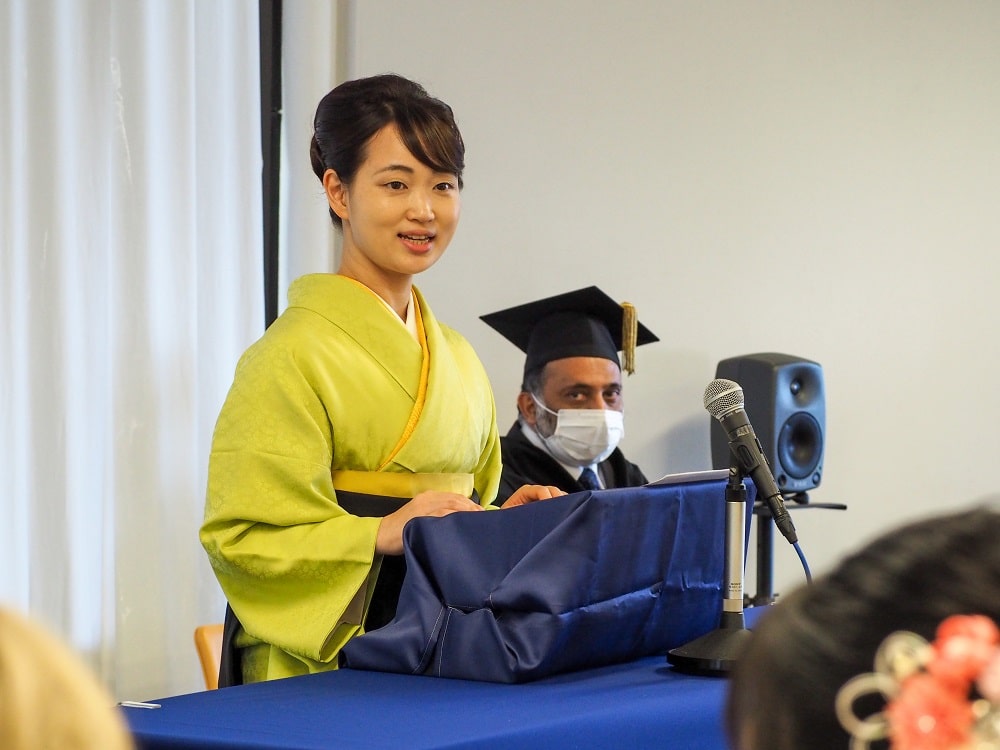 Yamanashi Gakuin University President Takako Aoyama gives a speech to iCLA graduates.