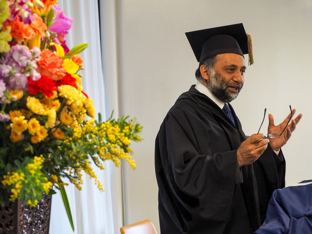 Dean Dr. Sanjay Jhingan giving a speech at iCLA's Spring 2023 Graduation Ceremony.