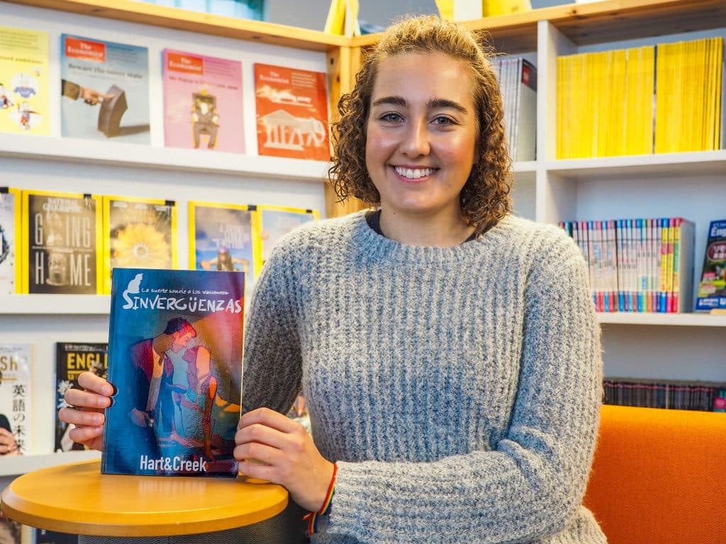 iCLA student Dania poses with a copy of Sinvergüenzas