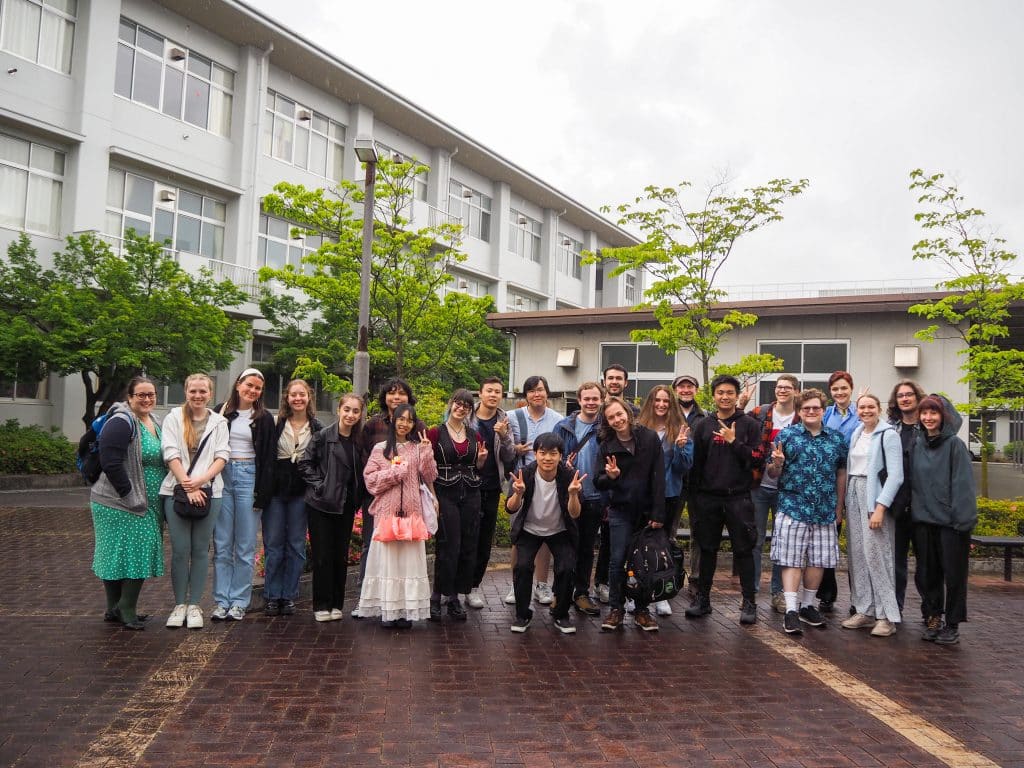 iCLA students pose in front of a Yamanashi high school after the iEXPerience trip