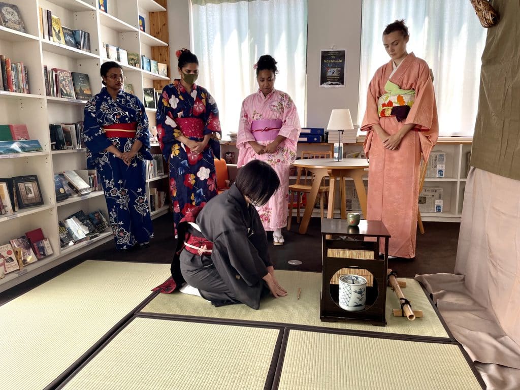 LAC staff member and iCLA students practice tea ceremony in LAC. 