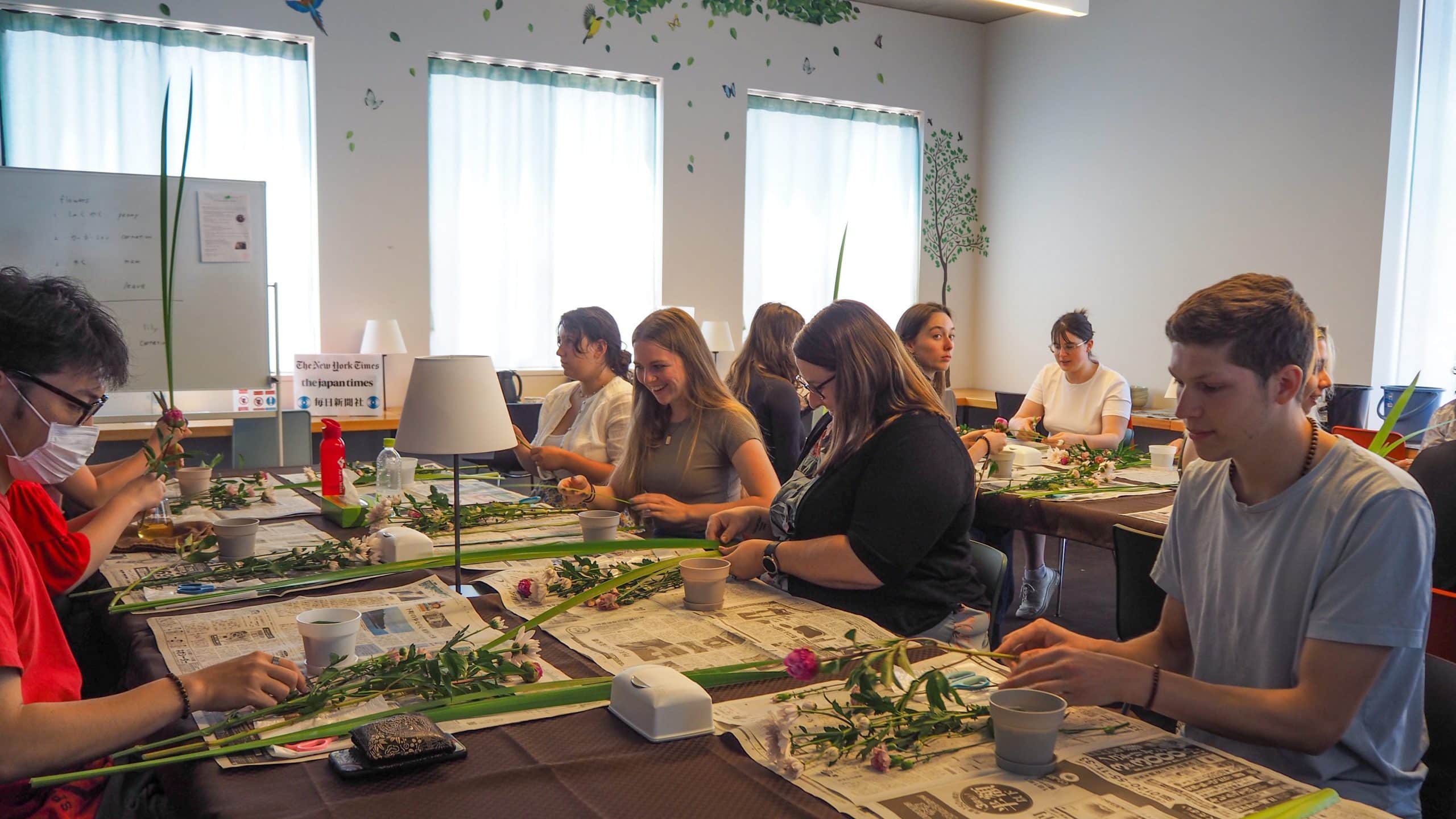 iCLA students try flower arrangement as part of the O-Chat Time events in LAC