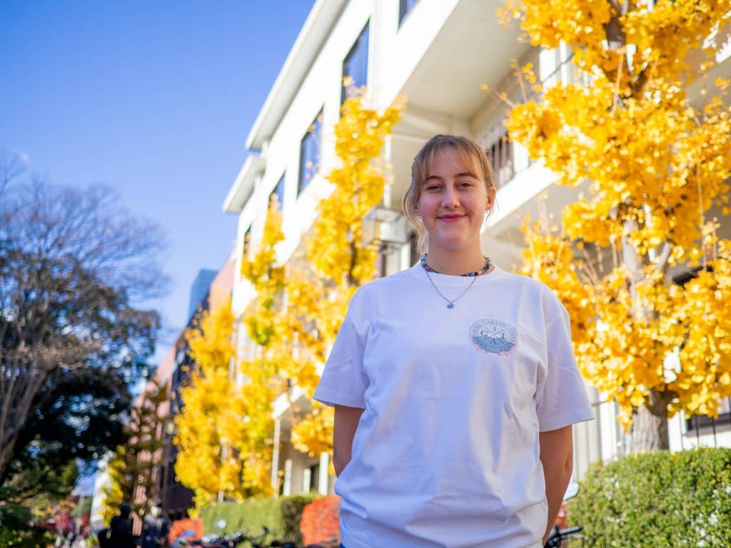 iCLA exchange student wears t-shirt with her logo design.