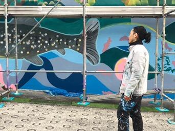 Gaku Okata works on his large scale public mural at the Somaguchi Water Purification Facility in Yamanashi City.