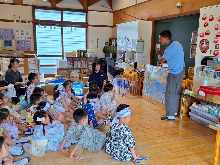 An iCLA student presents in front of the classroom about their home culture during the Star Festival. Yamanashi Gakuin kindergartners listen enthusiastically.