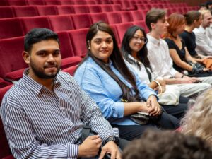 iCLA's new students smile while waiting for the entrance ceremony to begin.