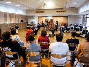 Nirasaki Kogyo High School students of the Taiko Club perform powerfully for iCLA students.