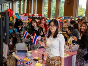 Students pose together at the Thailand booth.