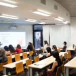 Professor Chun Yuen Terence Fong stands in front of a classroom of Psychology students, giving a talk. The talk is about Postgraduate options for Psychology.